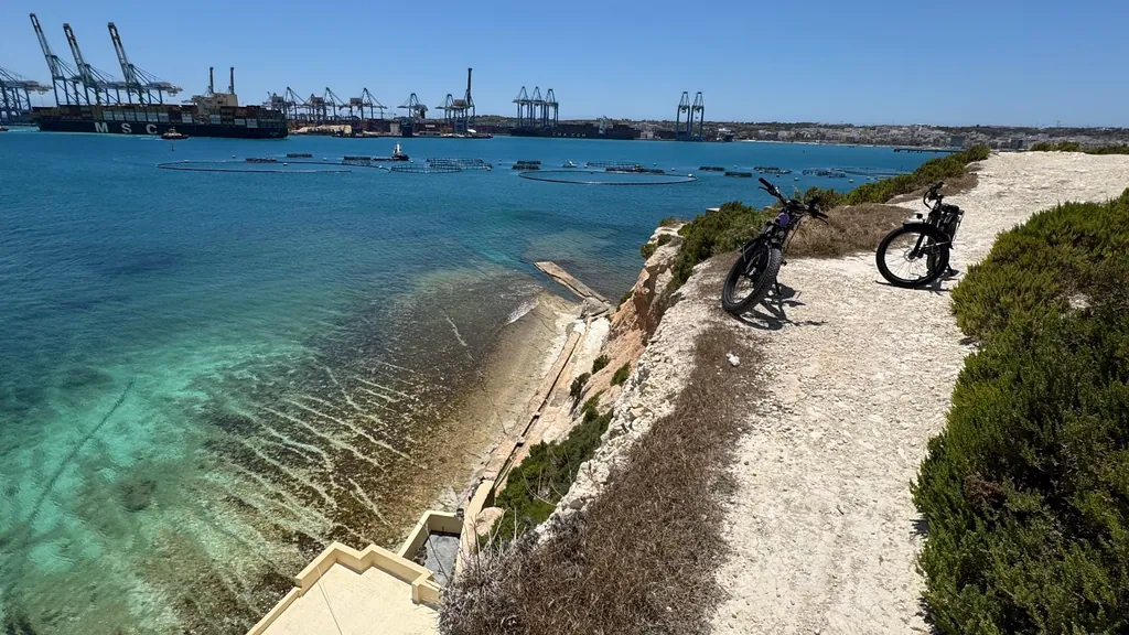 E-bikes on a coastal path above clear water in the south of Malta
