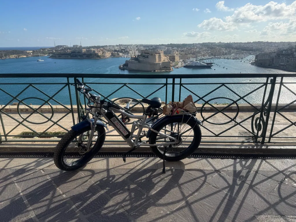 E-bike against the railings with a view over the Grand Harbour