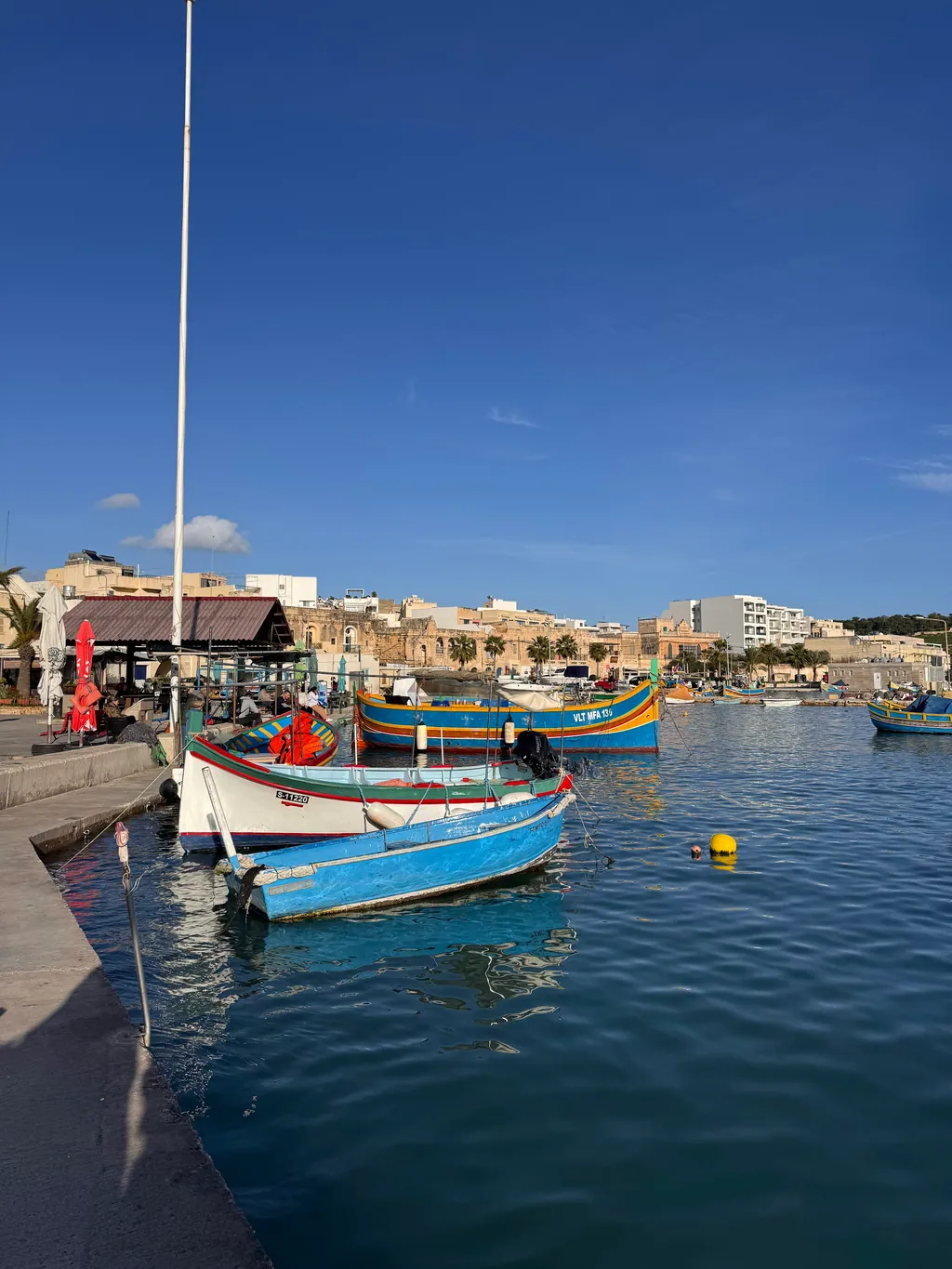Colourful luzzu fishing boats in Marsaxlokk harbour