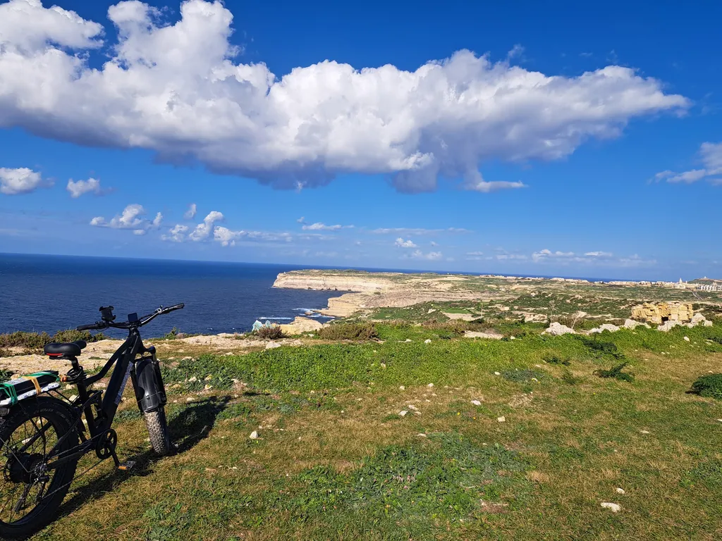 E-bike on the green clifftop above the sea at Dingli Cliffs